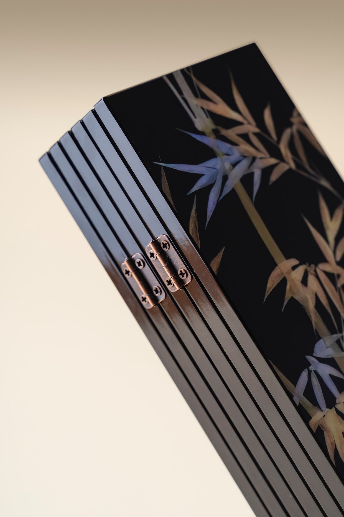 Black Bamboo mini folding screen folded, close-up of the copper hinges on the black lacquer edge