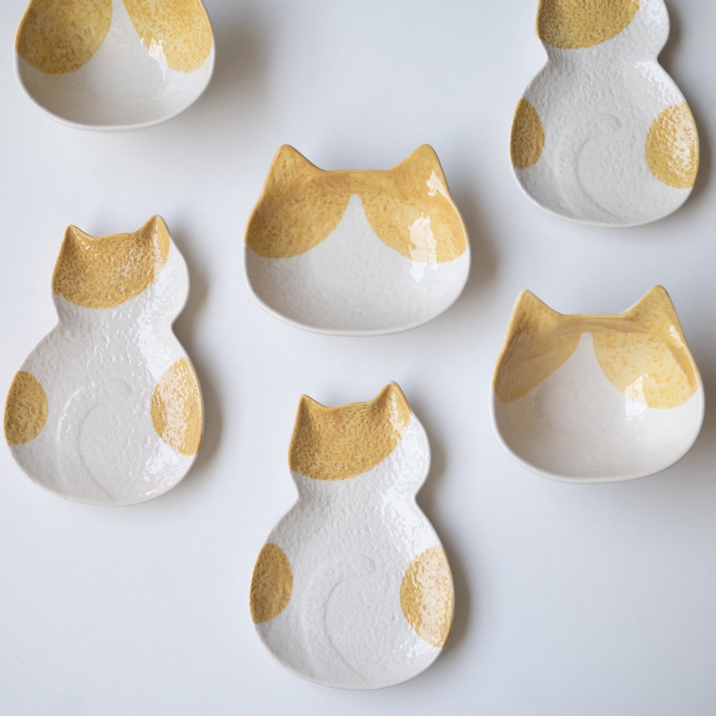 Speckled ear cat dishes with ginger ears, plates and bowls grouped