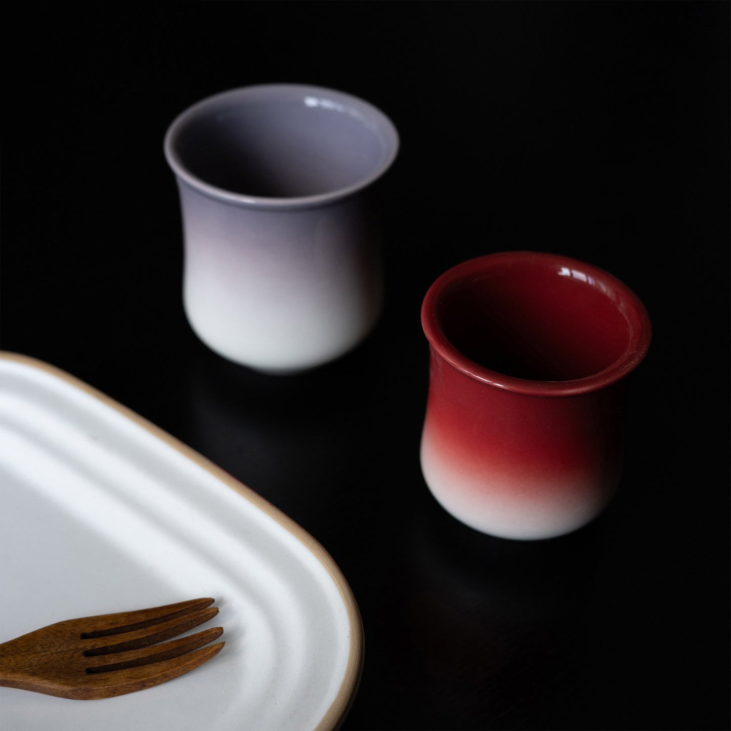 Gradient glaze tea cups in dusk purple and crimson on a white tray