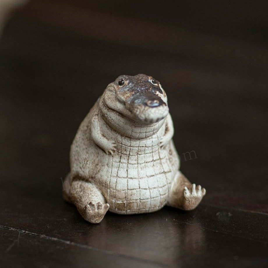 Little Crocodile Tea Pet sitting upright, pale clay belly and dark hand-coloured back