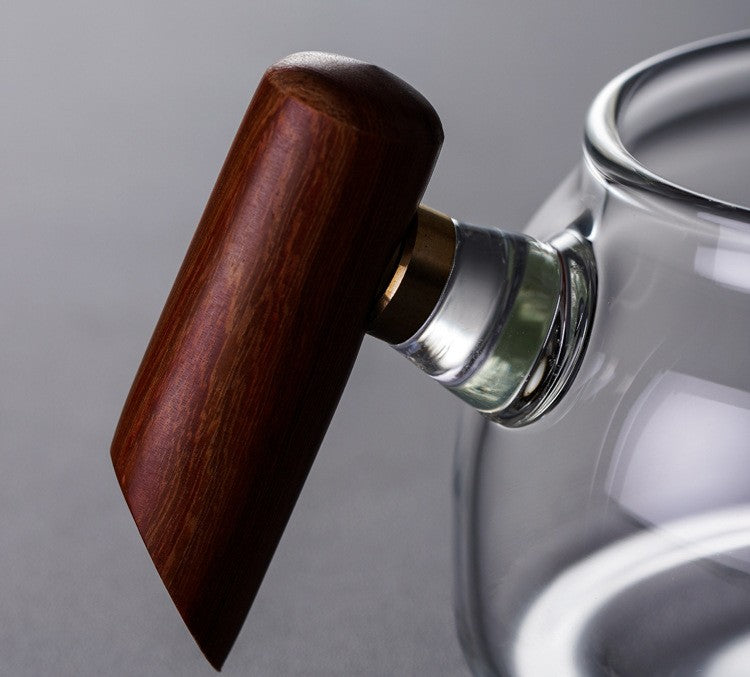 Close-up of the solid wood handle and metal collar on the glass fairness cup