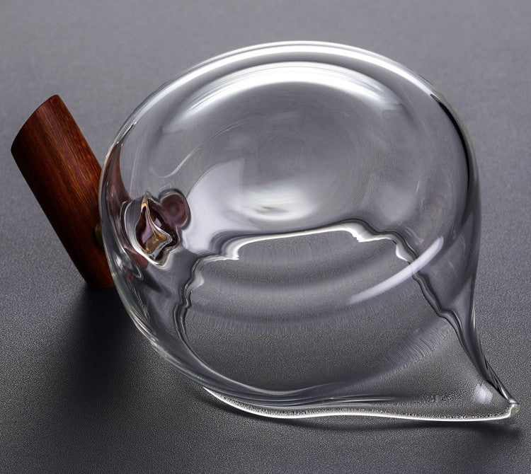 Top-down view of the wooden handle fairness cup showing the rim and pulled glass spout