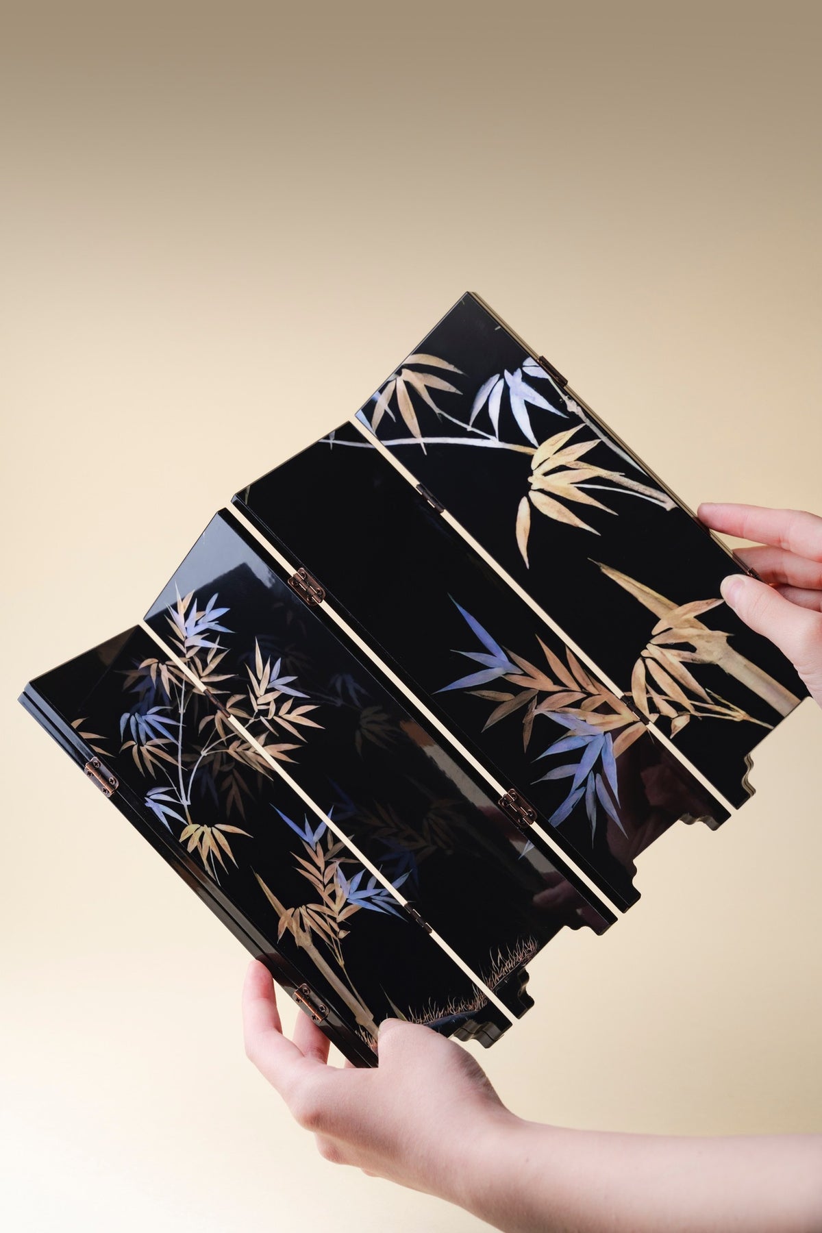 Black Bamboo mini folding screen, front bamboo side, held in two hands