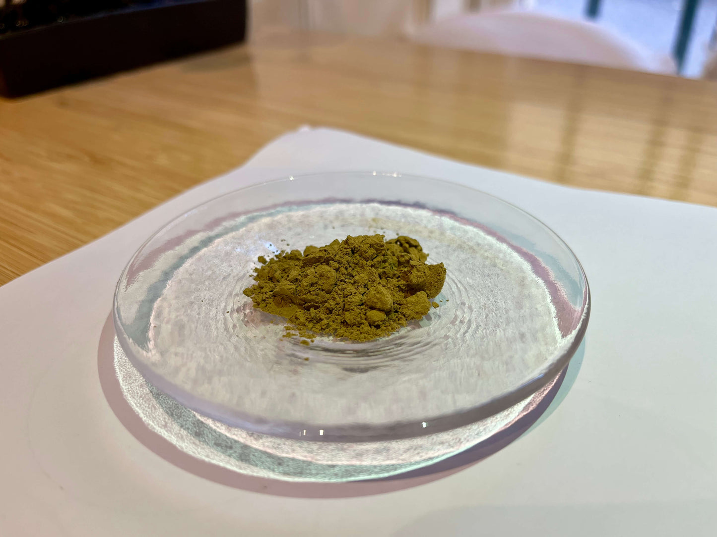 Roasted green tea powder for Hojicha Powder Amber on a glass plate