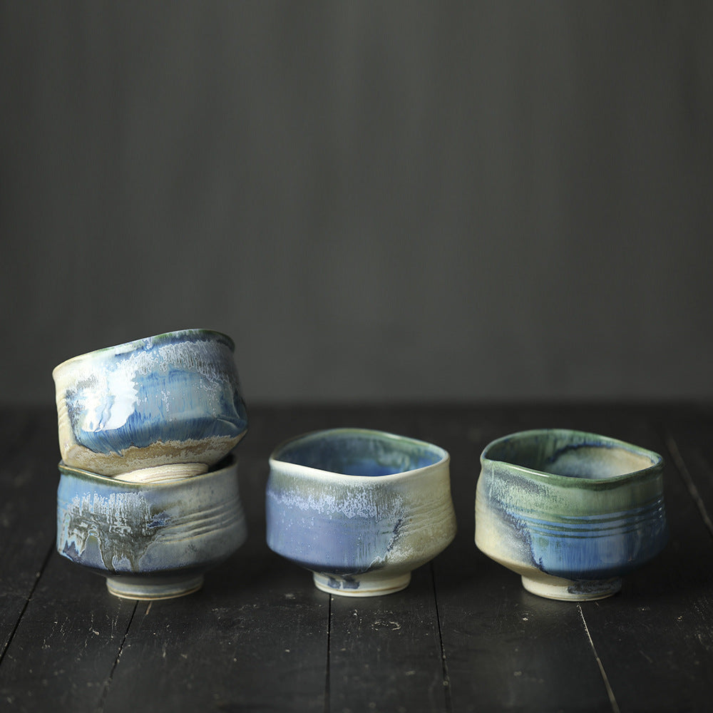 Different styles OF Matcha bowl with BLUE glaze on a dark wooden surface.