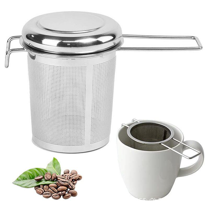 Stainless steel tea infuser basket with its lid, beside a white mug