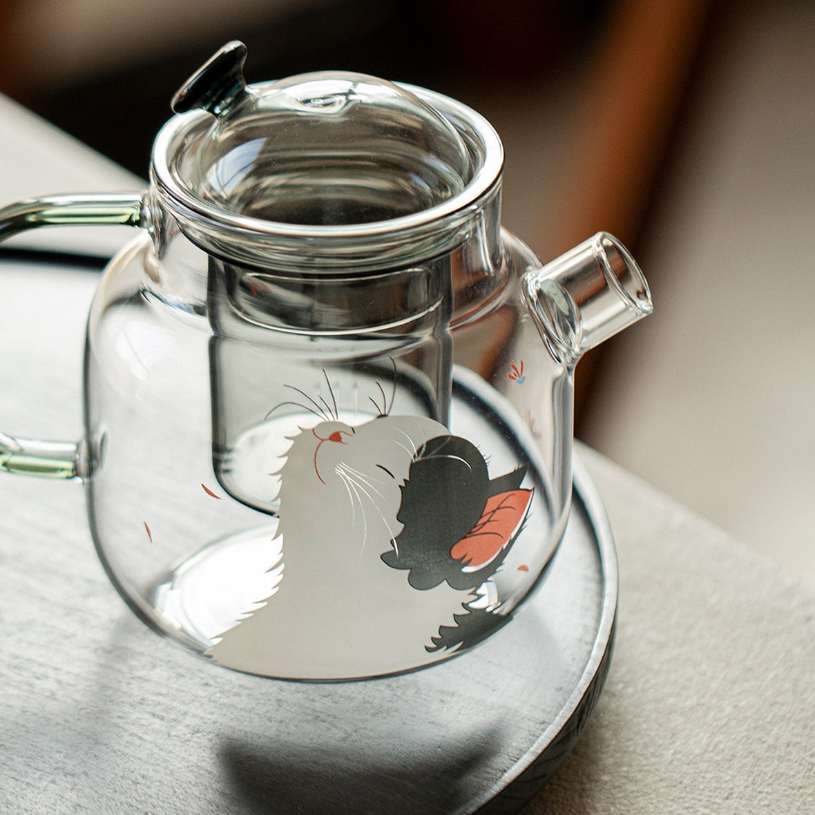 Top view of the 700ml glass teapot with the lid off, showing the rim of the glass infuser in the neck