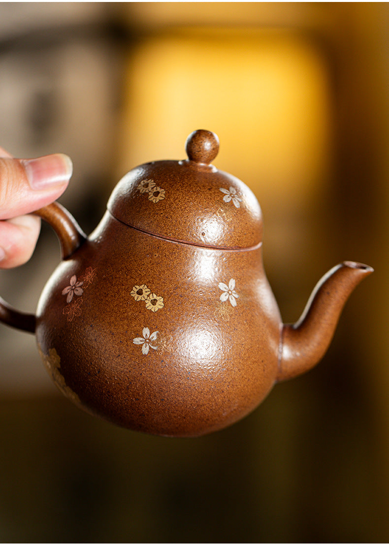 Rock clay flower and fish teapot held by the handle