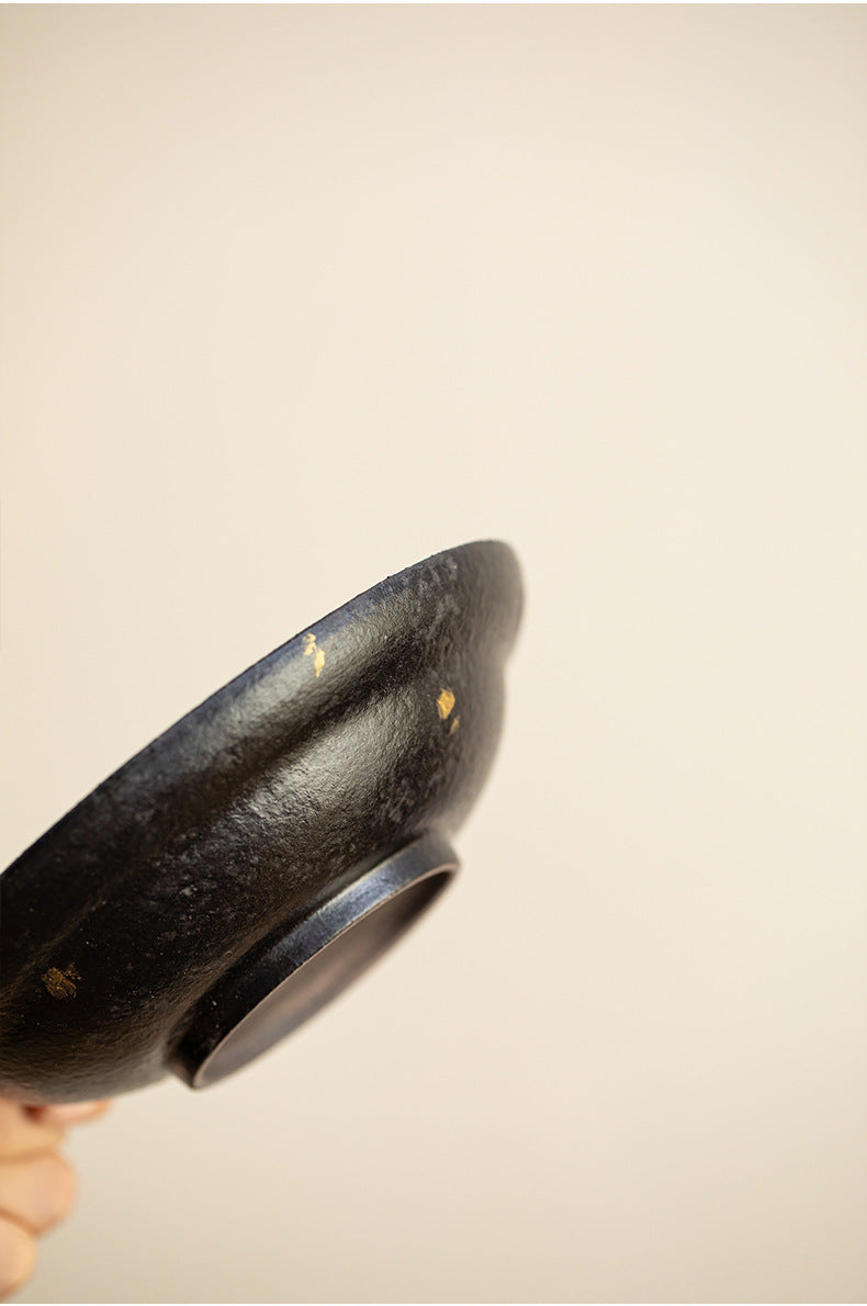 Underside of the black clay teapot stand showing the foot ring