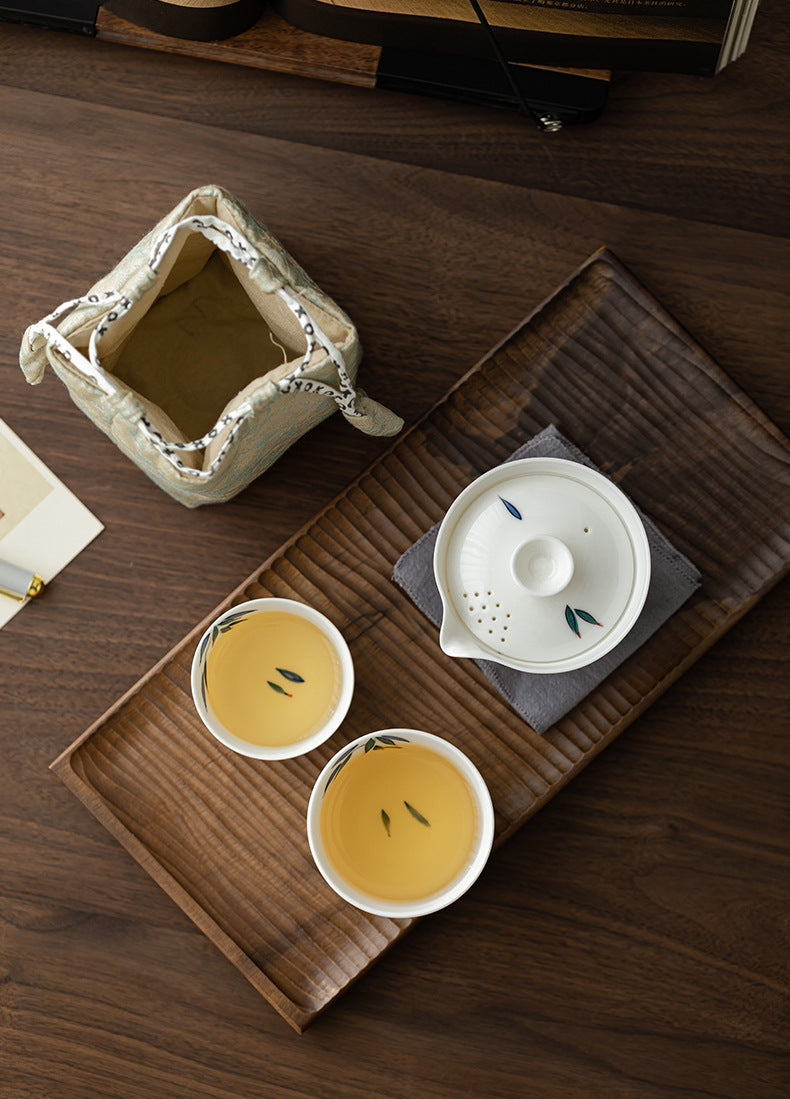 Tea set with two cups and a teapot on a wooden tray
