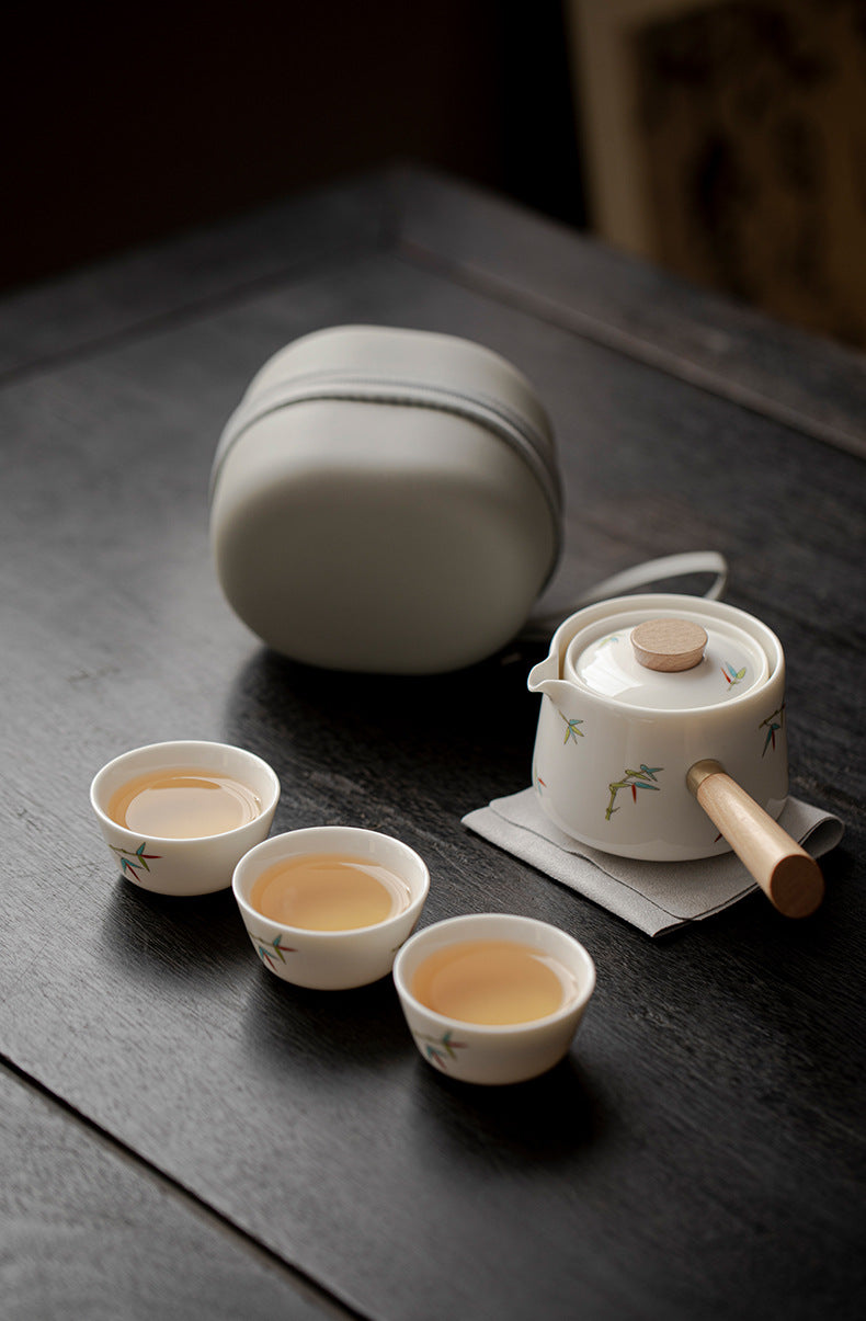 Tea set with teapot and cups on a dark surface