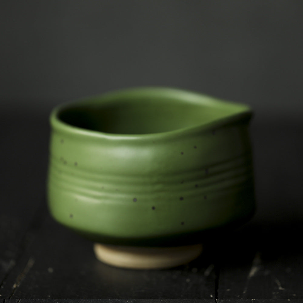 Green ceramic Matcha Bowl on a dark background