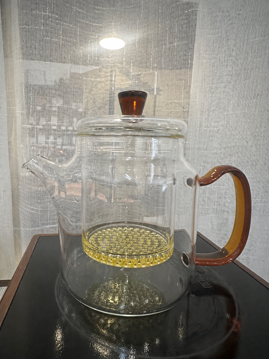 450ml Glass Teapot with Removable Infuser, amber glass handle and dark red lid knob, on a black stand in our Hobart shop