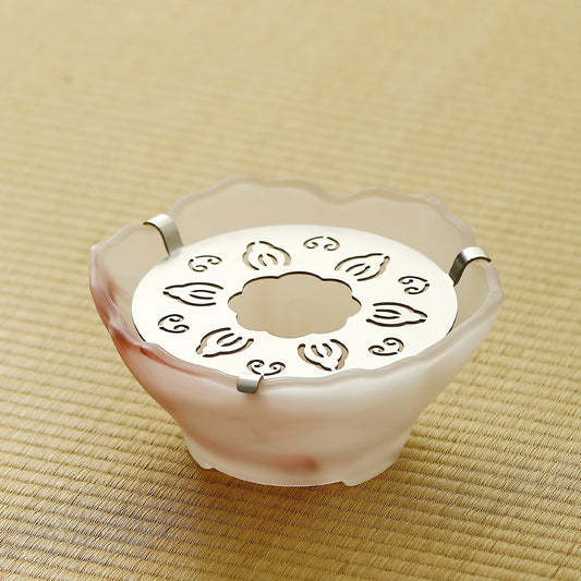 Pink frosted glass tea warmer with steel tealight plate on a tatami mat