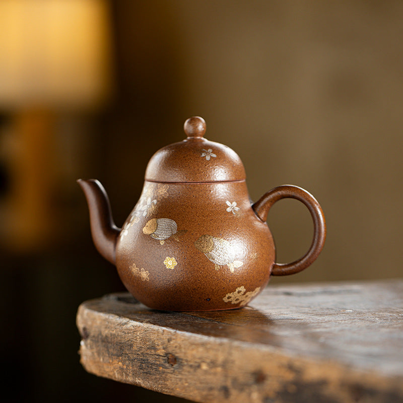 Rock clay siting teapot on the corner of a timber table