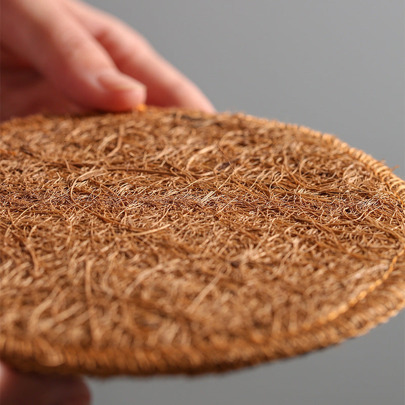 Close-up of the stitched edge and fibre of a loofah coaster