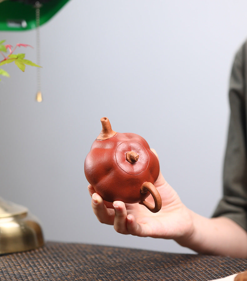 The Pumpkin Yixing clay teapot seen from above, showing the inset lid seam and the duan clay stem knob with its air hole