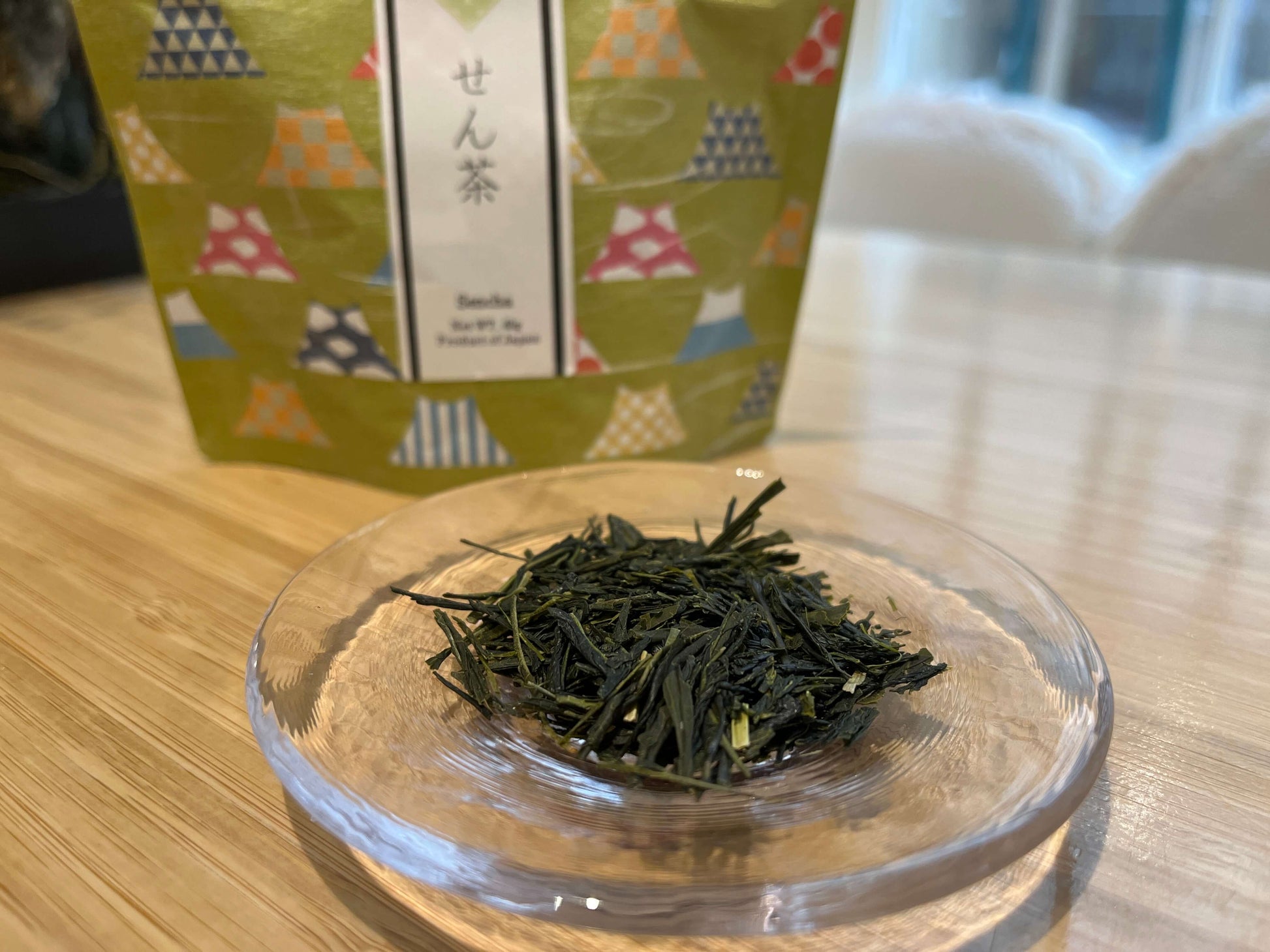 Wa no Sencha tea leaves in a clear dish with package in the background